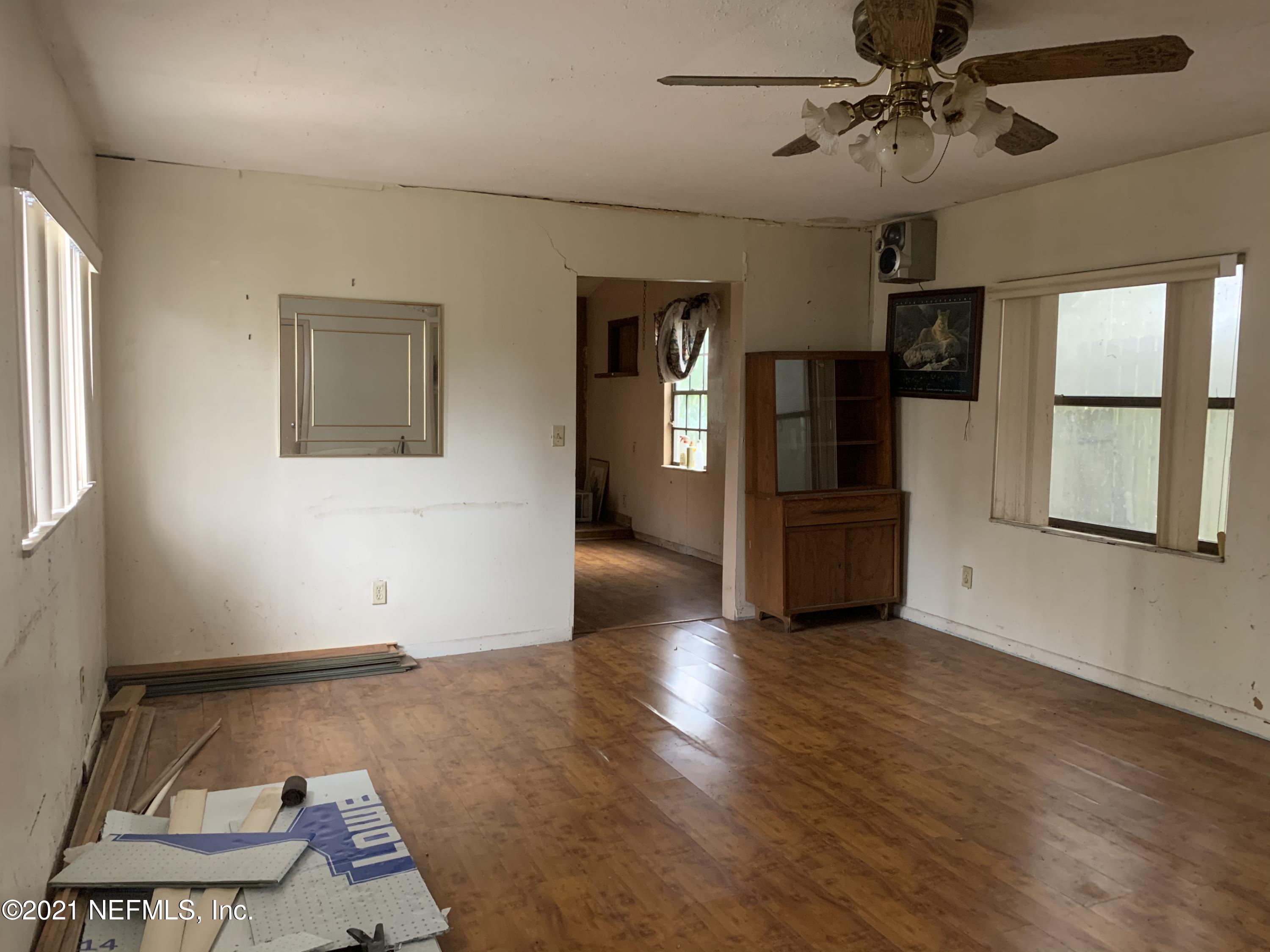3852 Grant Road Jacksonville, FL 32207 - Photo 10 of 25 a view of an empty room with a window and wooden floor