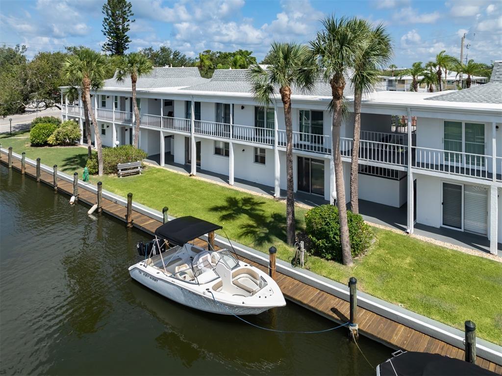 a view of a house with pool yard from a lake view