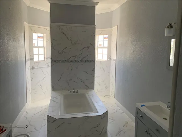 a bathroom with a sink a toilet and window