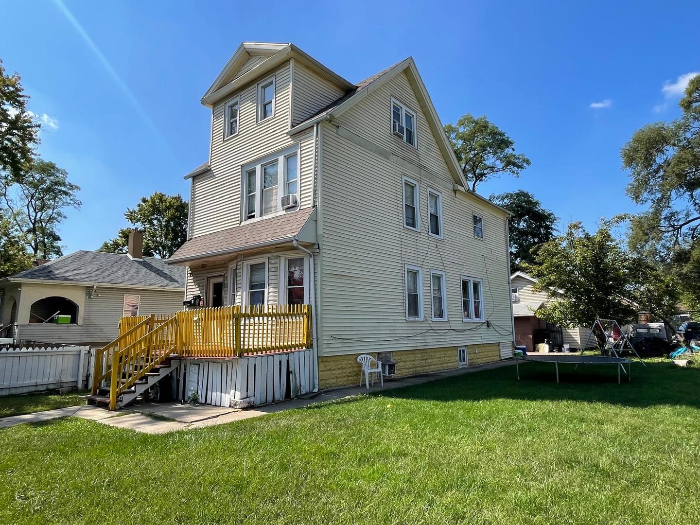 15736 Lathrop Avenue Harvey, IL 60426 - Photo 1 of 20 a view of backyard with a garden and deck