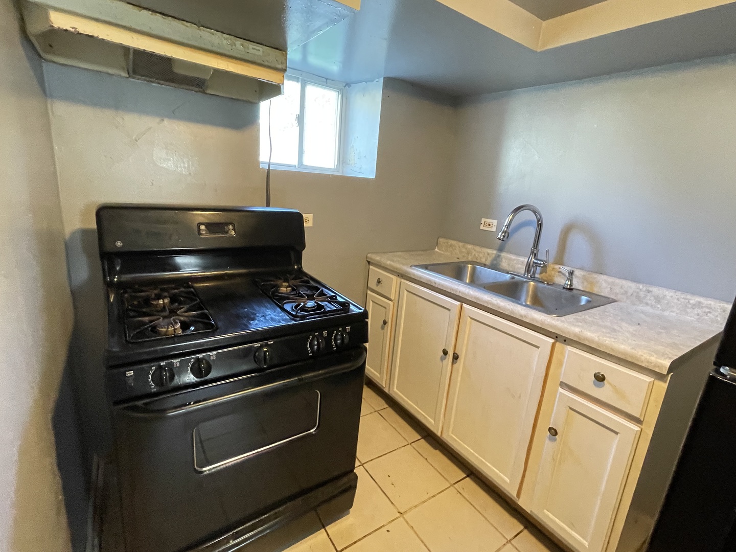 15736 Lathrop Avenue Harvey, IL 60426 - Photo 14 of 20 a kitchen with a stove and a sink