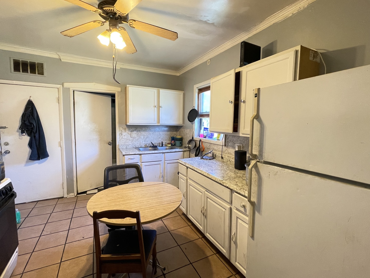 15736 Lathrop Avenue Harvey, IL 60426 - Photo 18 of 20 a kitchen with stainless steel appliances a refrigerator a sink a stove and white cabinets
