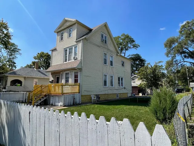 a front view of house with a garden