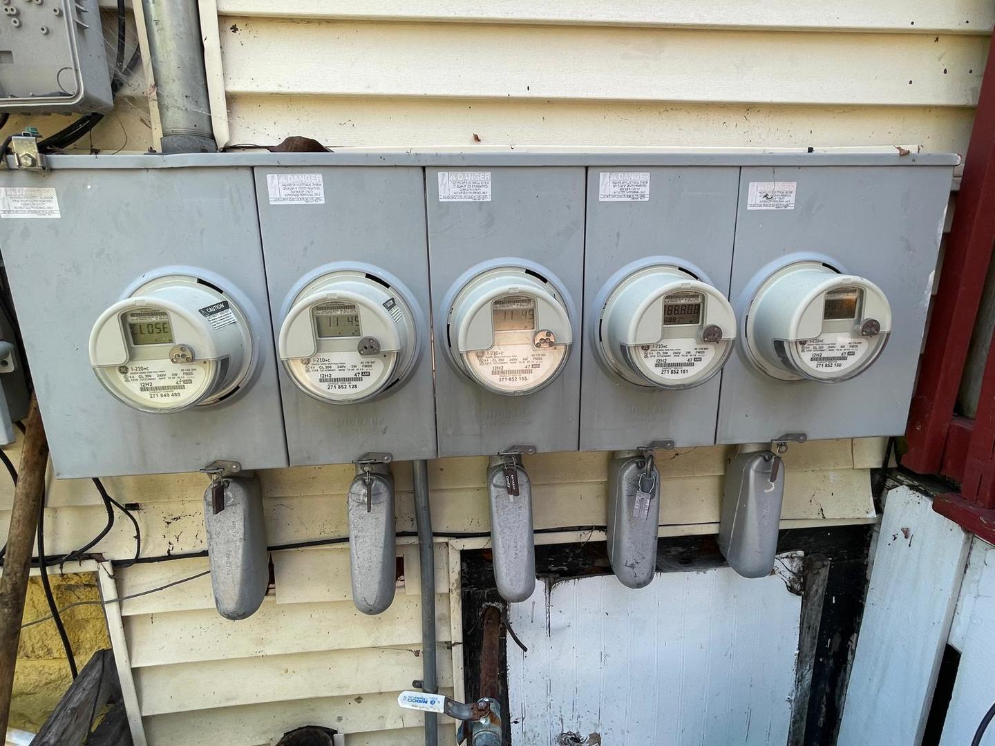 15736 Lathrop Avenue Harvey, IL 60426 - Photo 9 of 20 a area with cabinets and clock on the wall