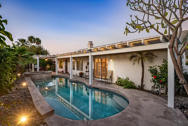 a view of a dining room with furniture large windows and wooden floor