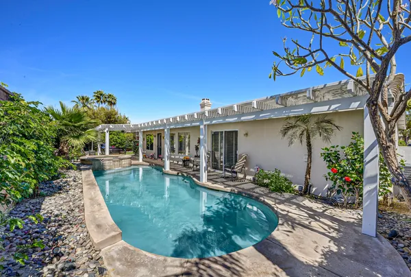 a dining room with furniture a chandelier and window
