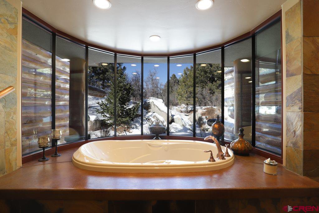 1900 County Road 124 Mancos, CO 81328 - Photo 17 of 35 a view of a swimming pool with a living room and floor to ceiling window