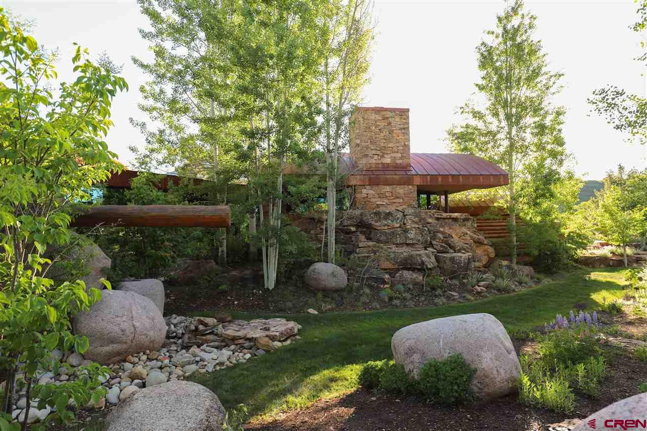 1900 County Road 124 Mancos, CO 81328 - Photo 24 of 35 a view of a garden with plants and a bench