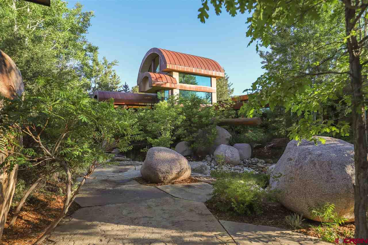 1900 County Road 124 Mancos, CO 81328 - Photo 3 of 35 a front view of a house with a yard and a tree