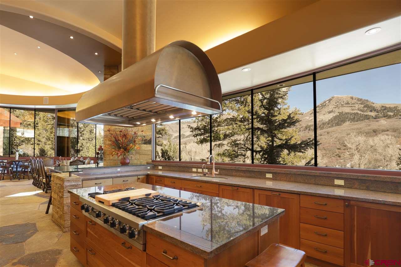 1900 County Road 124 Mancos, CO 81328 - Photo 7 of 35 a kitchen with a stove a sink and a wooden cabinets