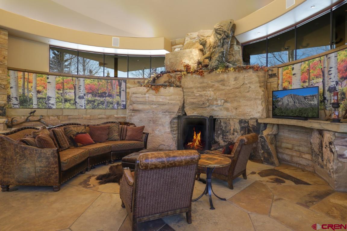 1900 County Road 124 Mancos, CO 81328 - Photo 10 of 35 a balcony with furniture and a fireplace