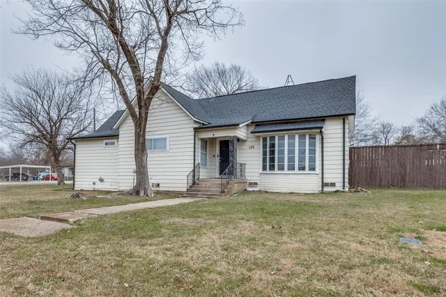 a house that has a tree in front of it