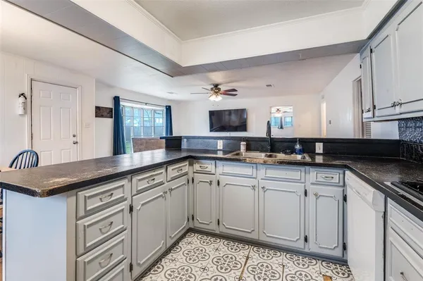 a kitchen with granite countertop a sink and cabinets