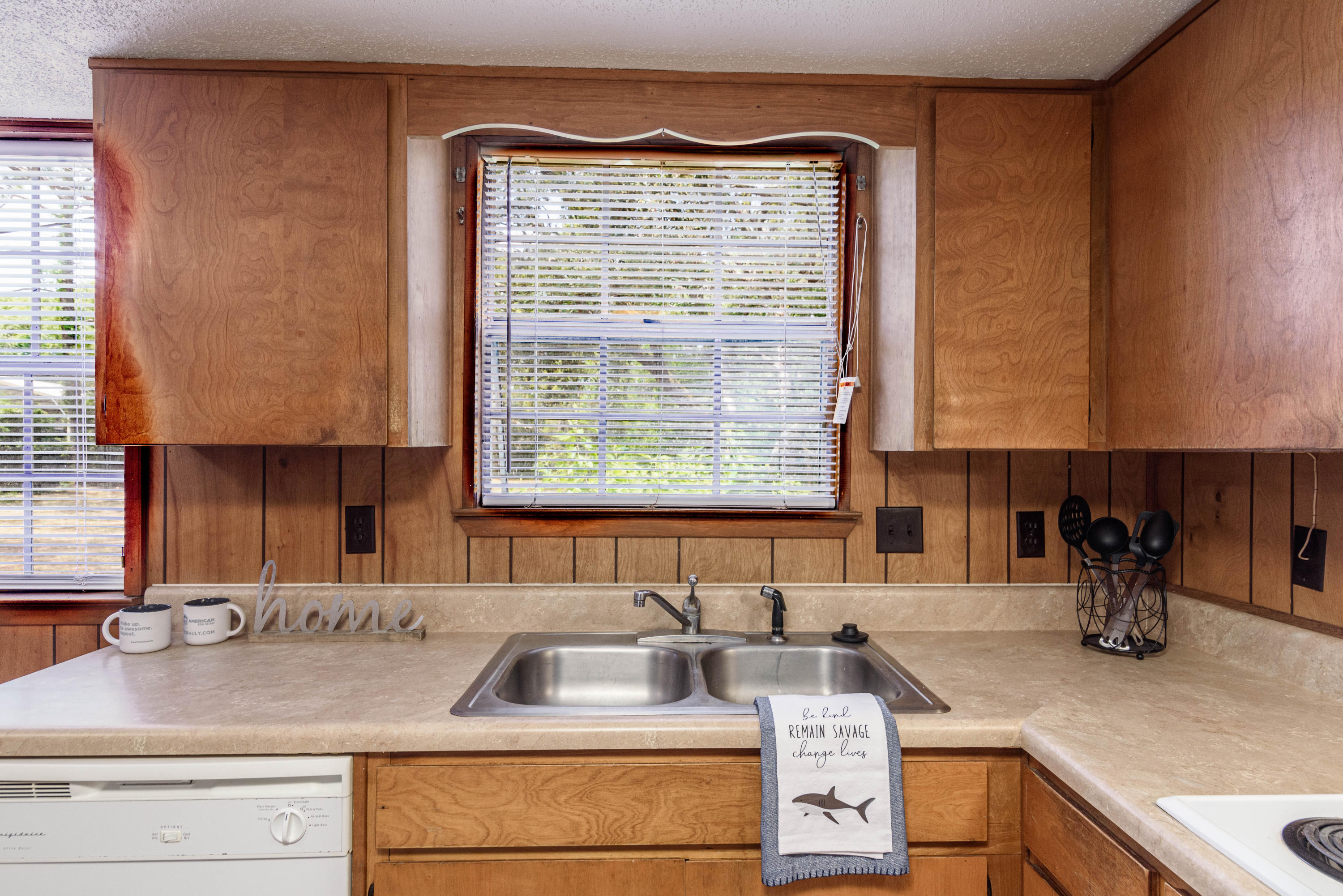 187 Country Club Road Shalimar, FL 32579 - Photo 15 of 68 a kitchen with sink a window and cabinets