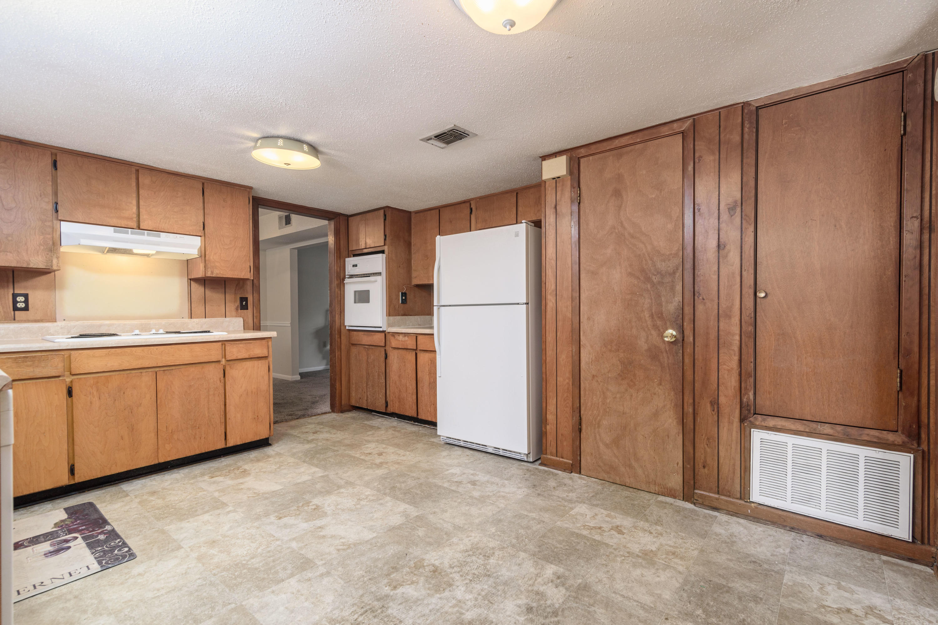 187 Country Club Road Shalimar, FL 32579 - Photo 18 of 68 a kitchen with a refrigerator a sink and cabinets