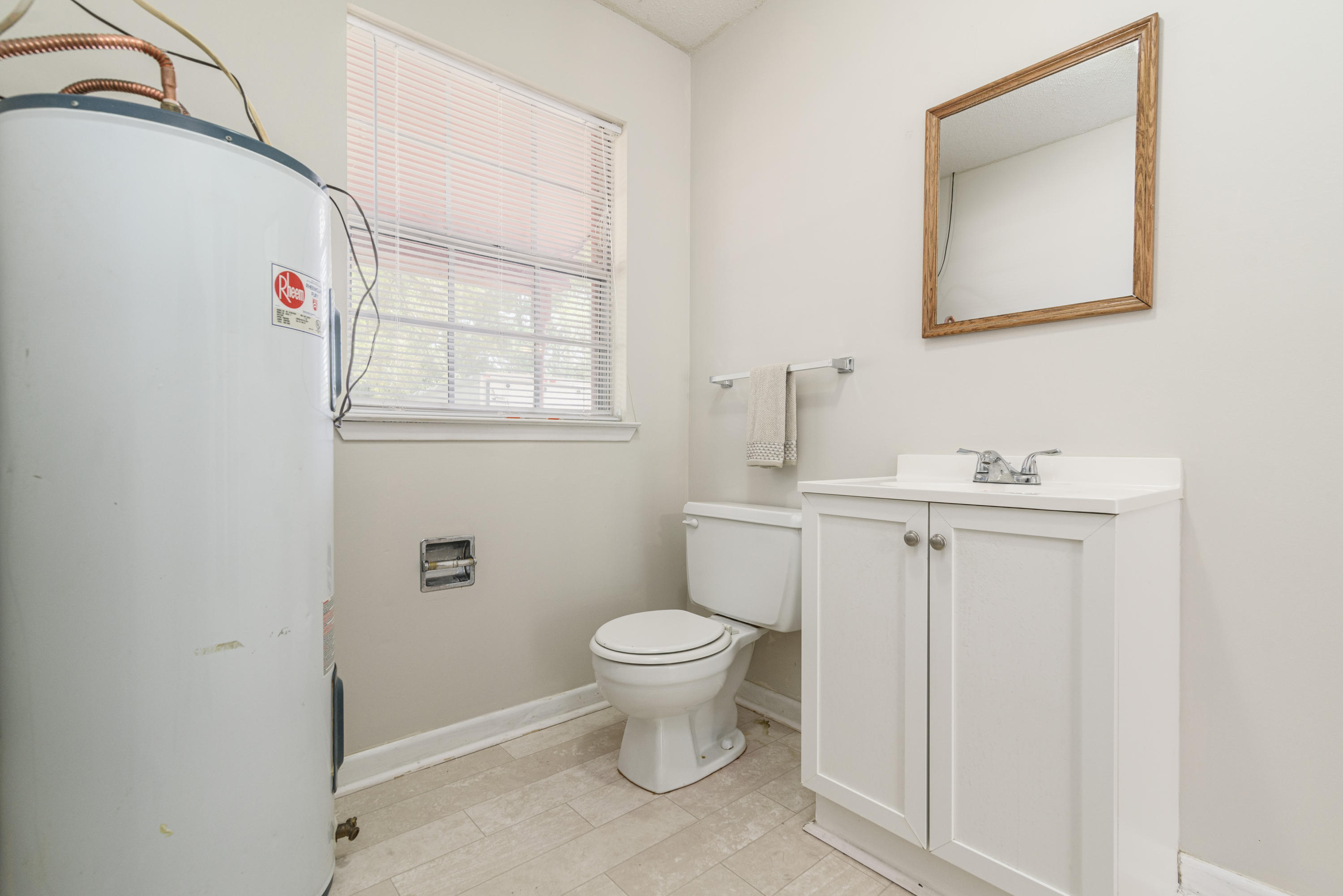 187 Country Club Road Shalimar, FL 32579 - Photo 26 of 68 a bathroom with a toilet sink and mirror
