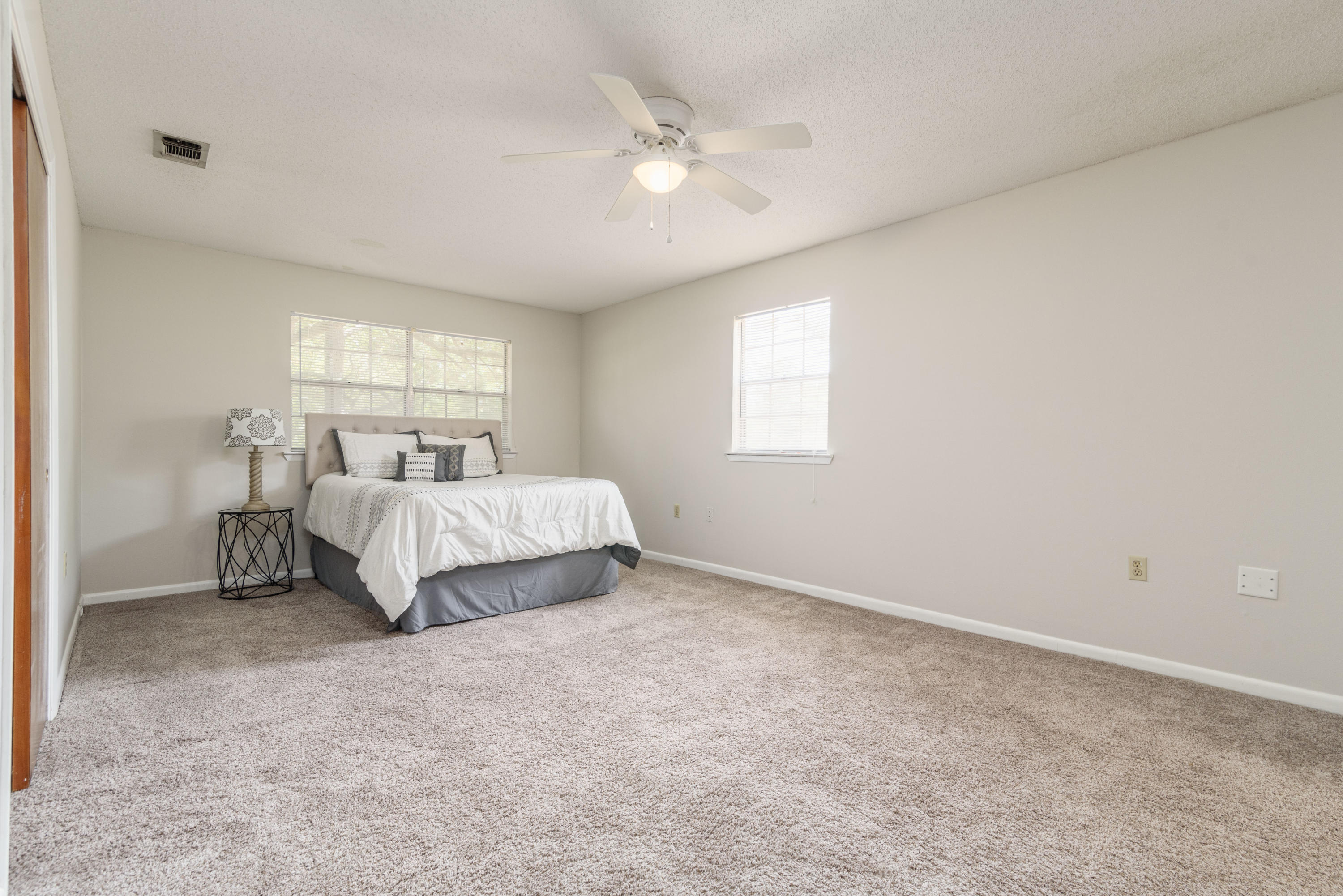 187 Country Club Road Shalimar, FL 32579 - Photo 31 of 68 a spacious bedroom with a bed and a window