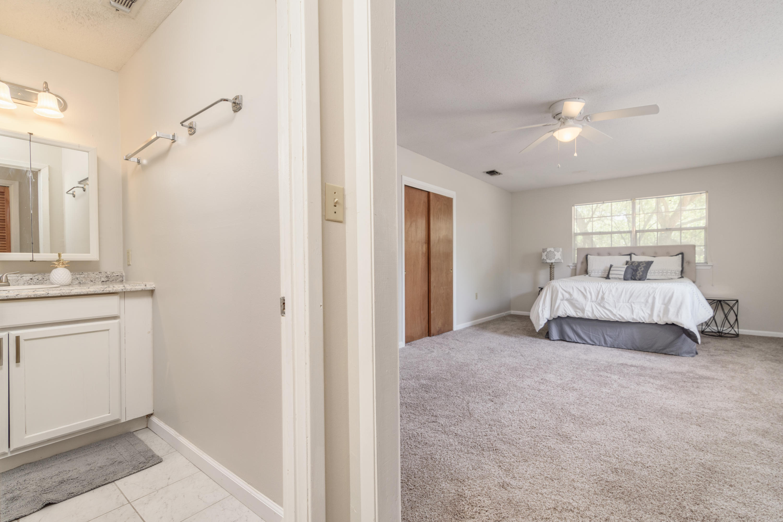 187 Country Club Road Shalimar, FL 32579 - Photo 33 of 68 a spacious bedroom with a bed and a window