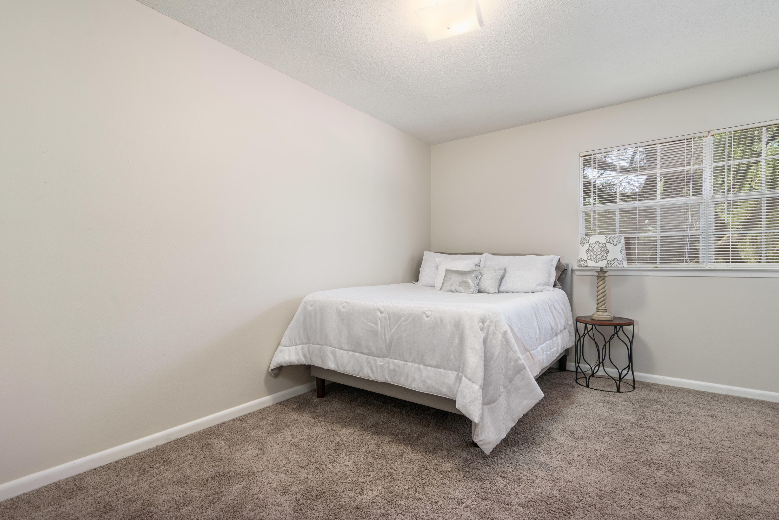 187 Country Club Road Shalimar, FL 32579 - Photo 39 of 68 a bedroom with a bed and a window