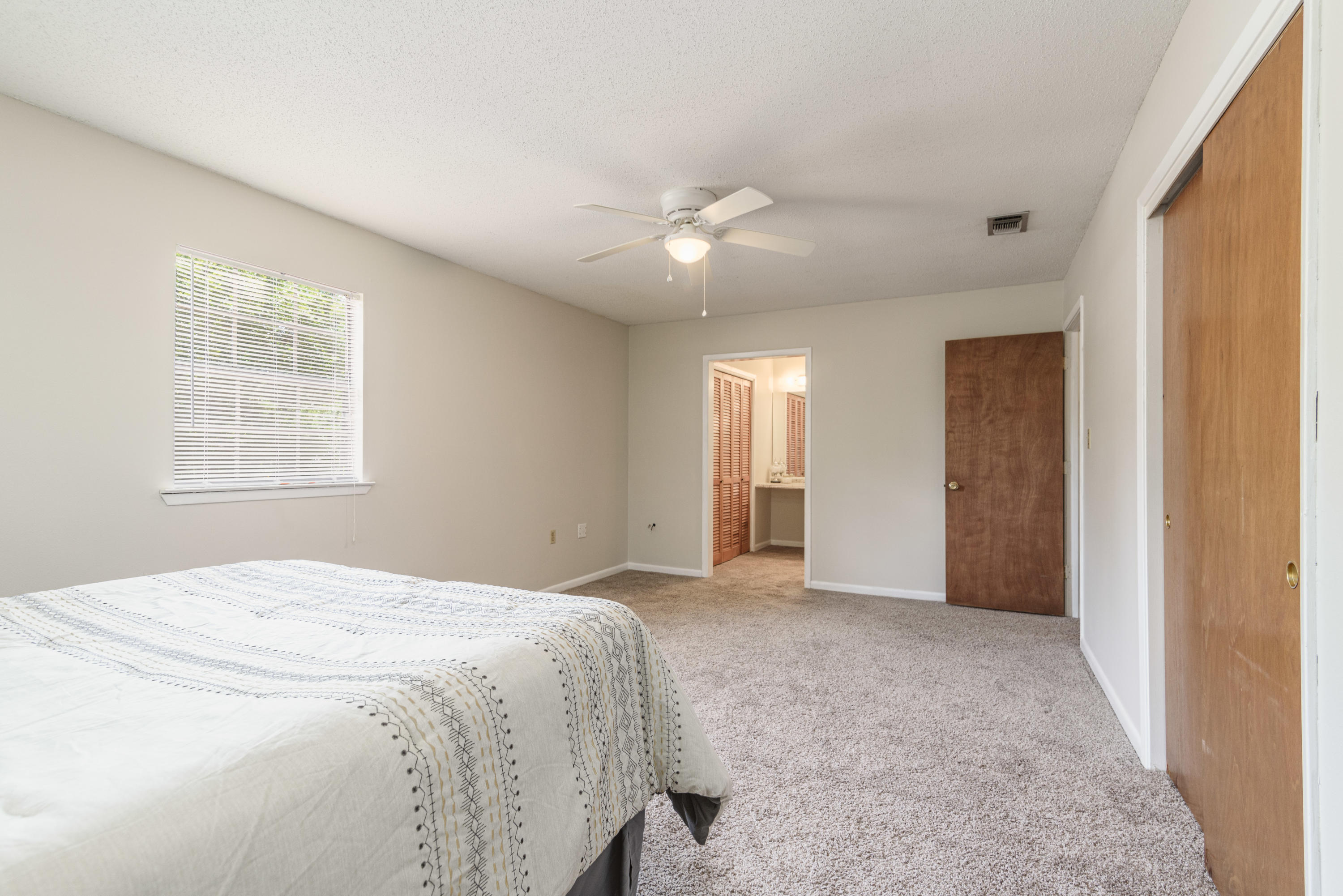 187 Country Club Road Shalimar, FL 32579 - Photo 40 of 68 a spacious bedroom with a large bed and a window