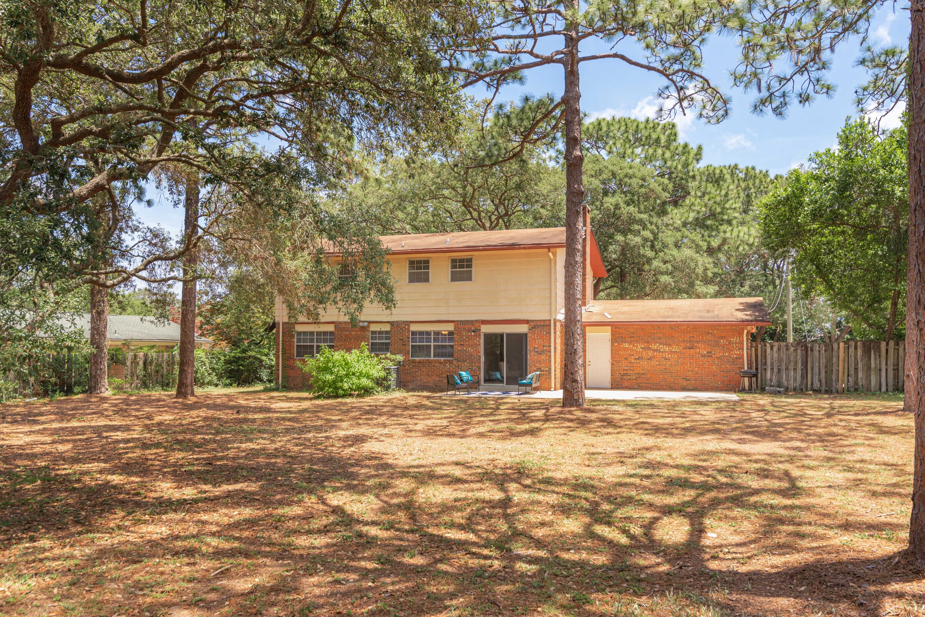 187 Country Club Road Shalimar, FL 32579 - Photo 53 of 68 a front view of a house with a yard and garage