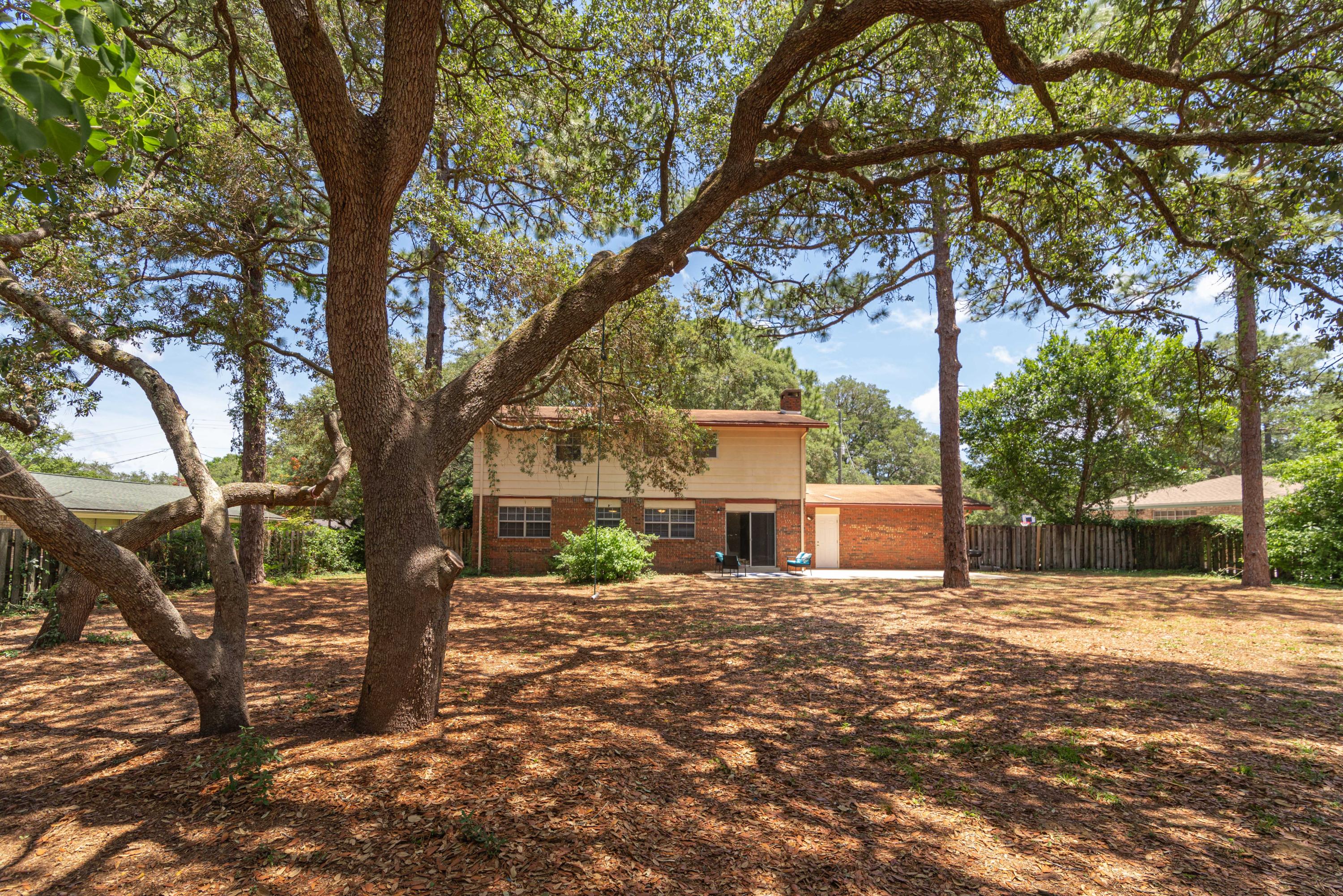 187 Country Club Road Shalimar, FL 32579 - Photo 54 of 68 a white house that has a tree in front of a house