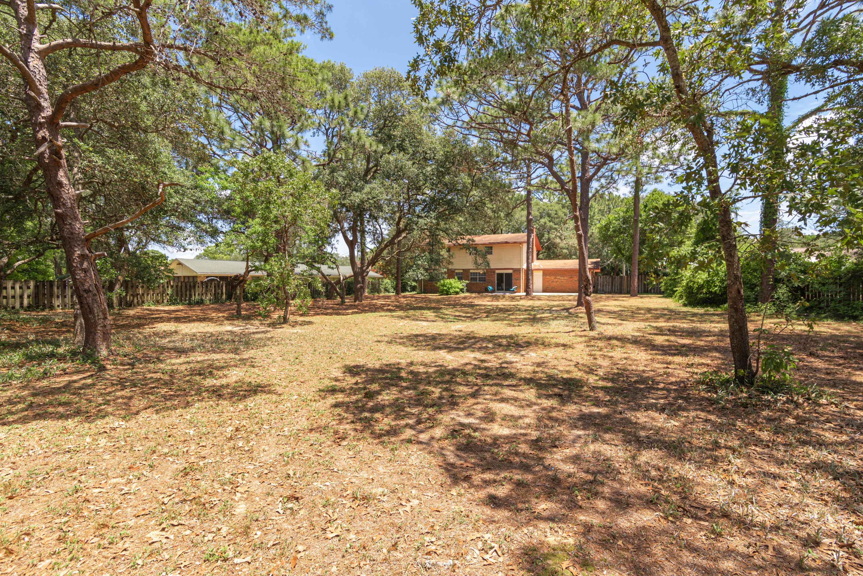187 Country Club Road Shalimar, FL 32579 - Photo 56 of 68 a house with trees in front of it