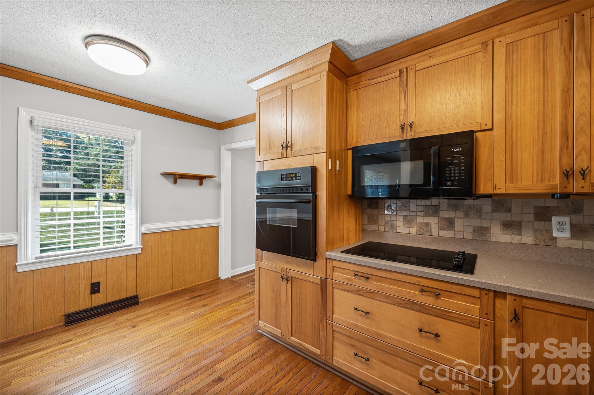 1412 Ebinport Road Rock Hill, SC 29732 - Photo 14 of 35 a kitchen with stainless steel appliances wooden cabinets a stove and a microwave