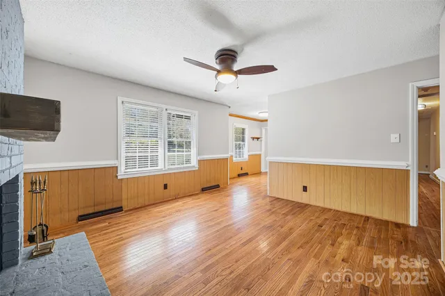a view of a room with wooden floor and windows
