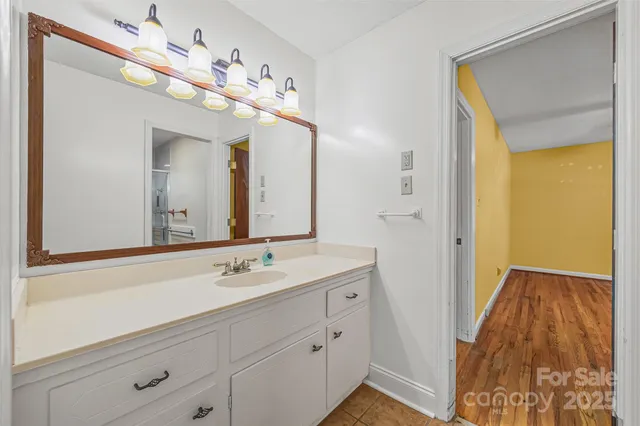a spacious bathroom with a double vanity sink and a mirror
