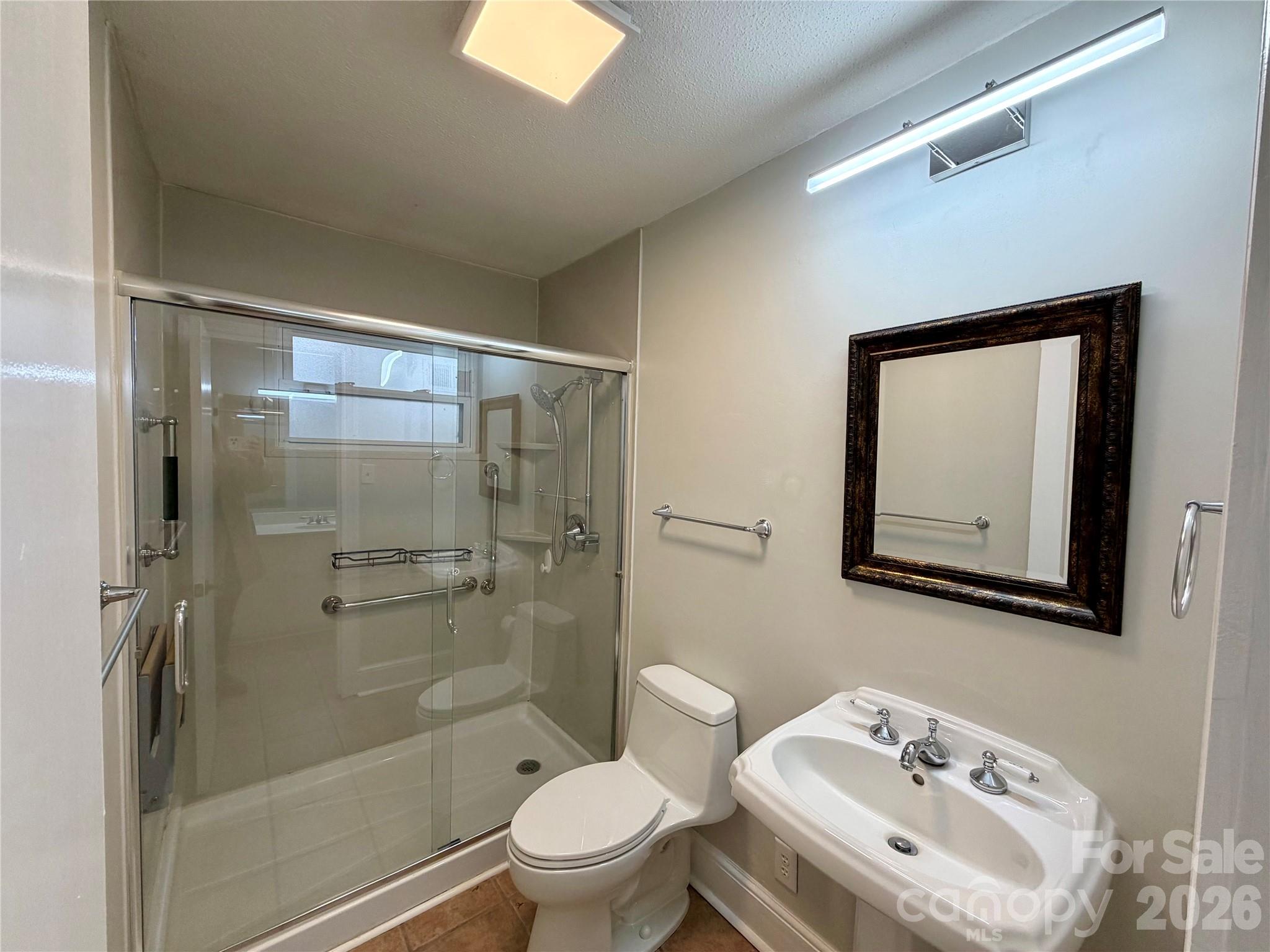 1412 Ebinport Road Rock Hill, SC 29732 - Photo 24 of 35 a bathroom with a toilet sink vanity and shower