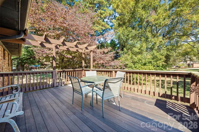 a view of a patio with table and chairs and wooden floor