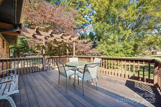 a view of a balcony with wooden floor and outdoor seating