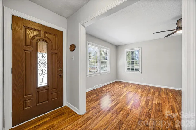 a living room with furniture ceiling fan and a window