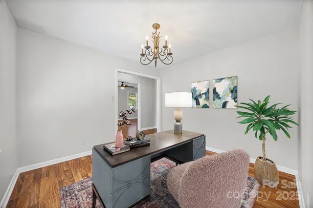 a view of a livingroom with furniture and a potted plant