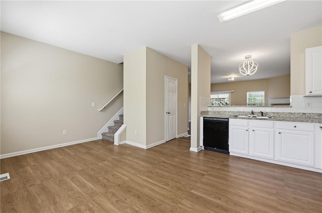 2335 Meadow Peak Point Duluth, GA 30097 - Photo 11 of 32 a view of a kitchen with a sink a fireplace and wooden floor