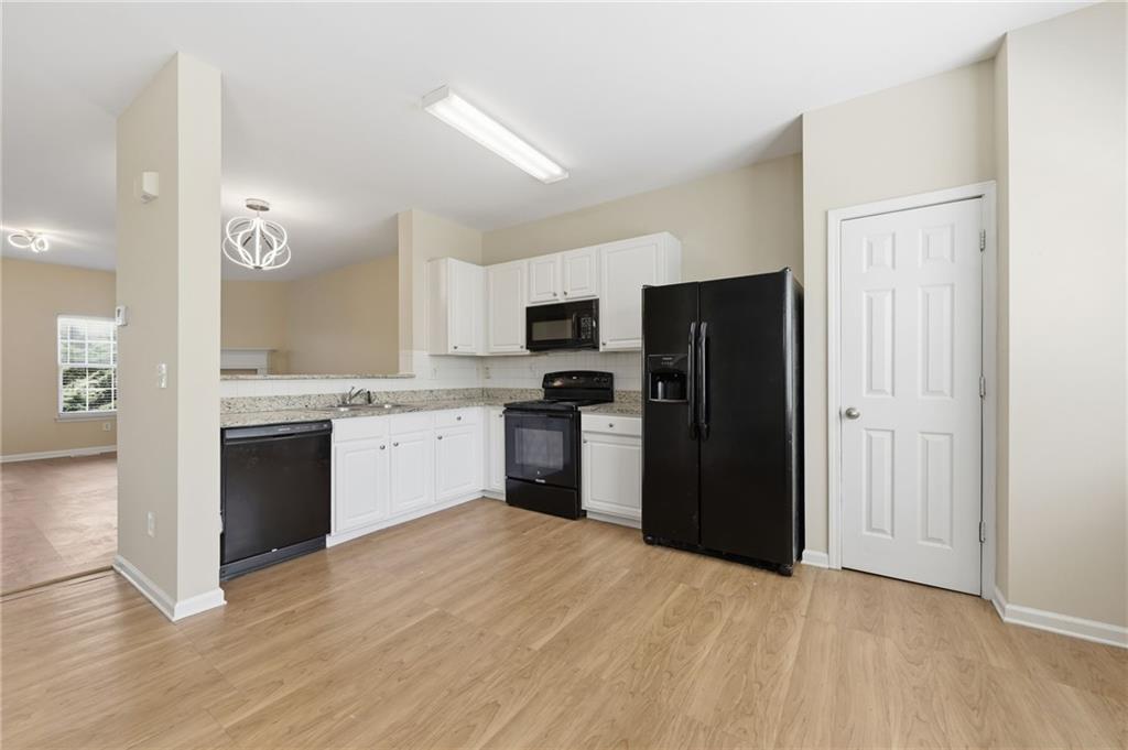 2335 Meadow Peak Point Duluth, GA 30097 - Photo 12 of 32 a kitchen with a refrigerator and a stove top oven