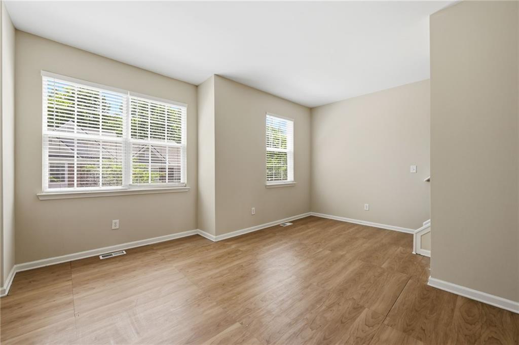 2335 Meadow Peak Point Duluth, GA 30097 - Photo 14 of 32 an empty room with wooden floor and windows