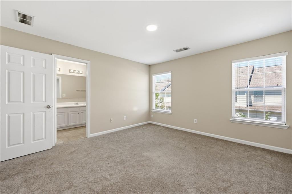 2335 Meadow Peak Point Duluth, GA 30097 - Photo 17 of 32 an empty room with windows and closet