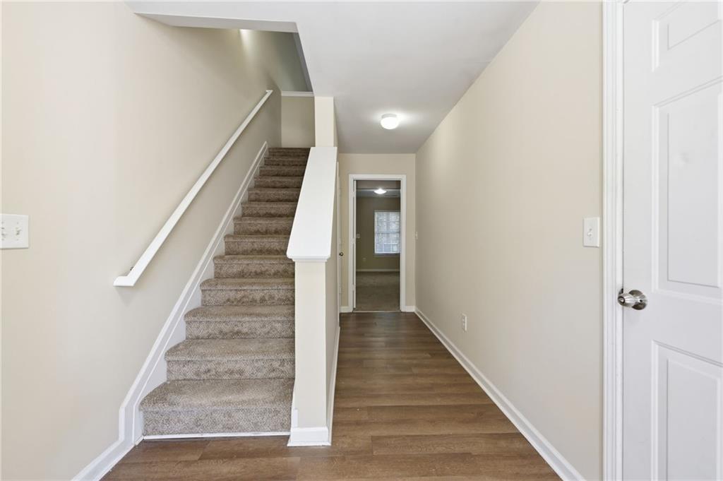 2335 Meadow Peak Point Duluth, GA 30097 - Photo 2 of 32 a view of a hallway with wooden floor and entryway