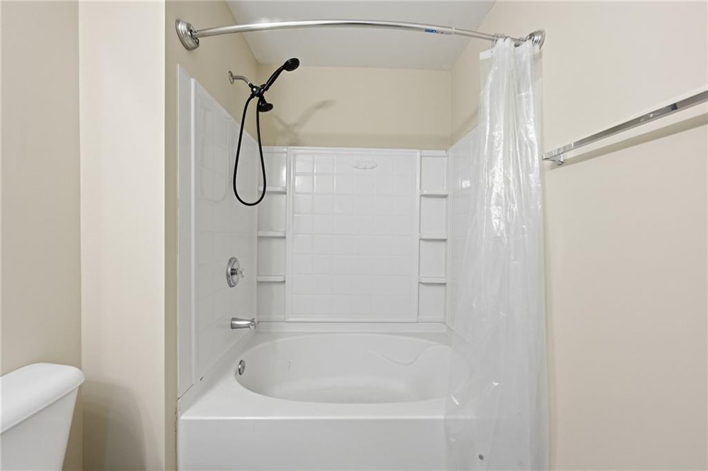 2335 Meadow Peak Point Duluth, GA 30097 - Photo 21 of 32 a bathroom with a bath tub with a shower