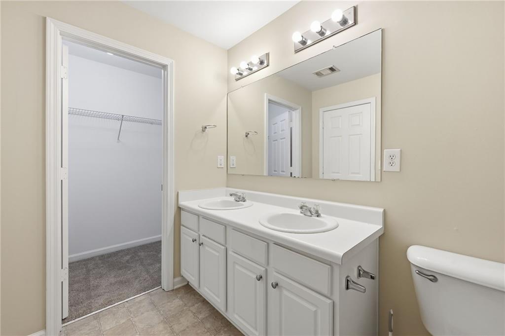 2335 Meadow Peak Point Duluth, GA 30097 - Photo 22 of 32 a spacious bathroom with a shower sink and mirror