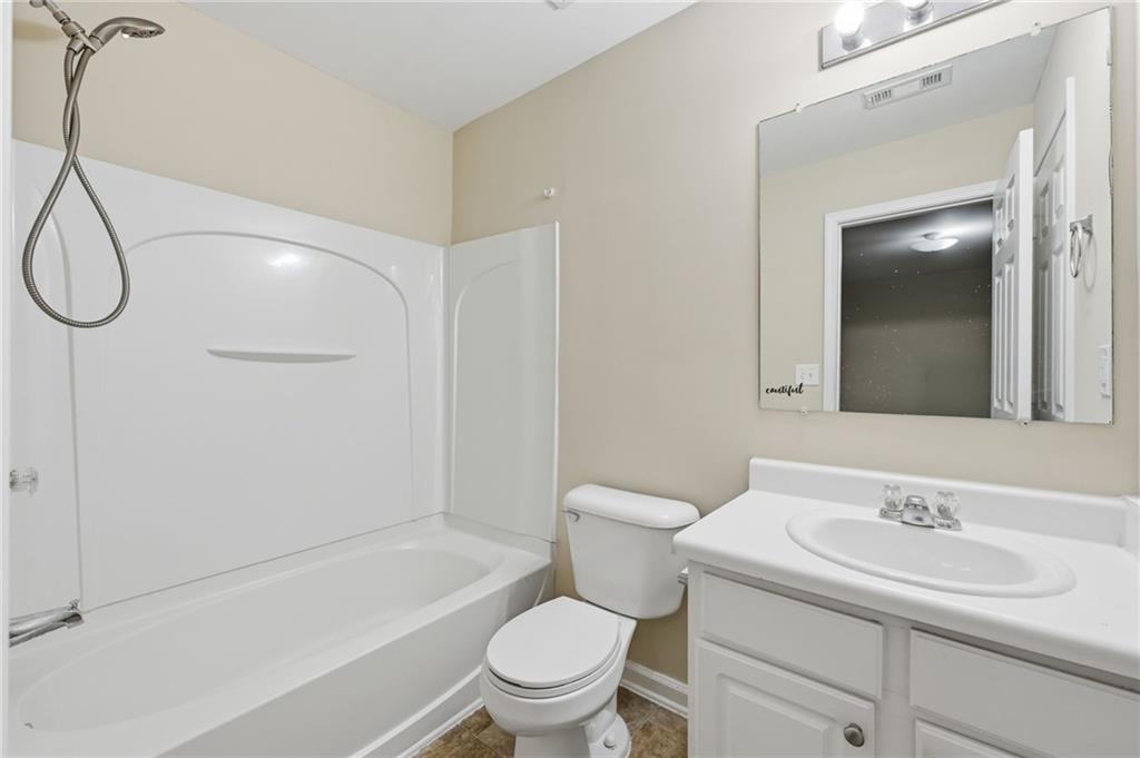 2335 Meadow Peak Point Duluth, GA 30097 - Photo 5 of 32 a bathroom with a sink a toilet and shower