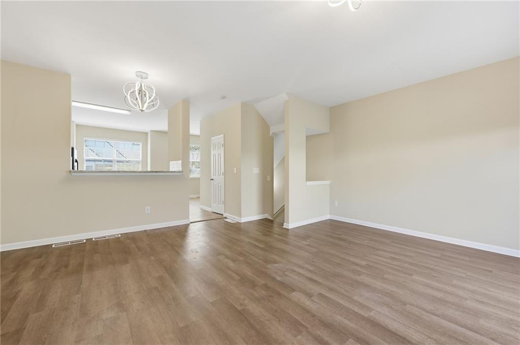 2335 Meadow Peak Point Duluth, GA 30097 - Photo 9 of 32 a view of an empty room with wooden floor and a window