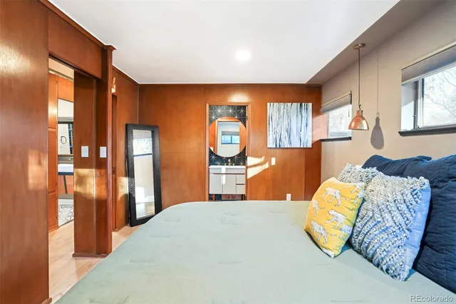 a bedroom with a large bed and a chandelier