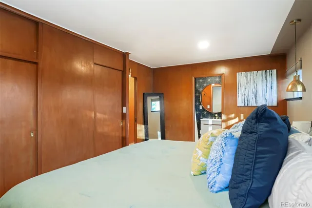 a bed room with a bed and mirror