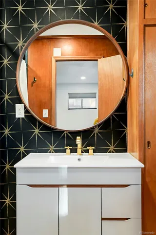 a bathroom with a sink and mirror