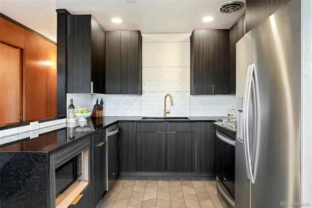 a kitchen with a sink stove and refrigerator