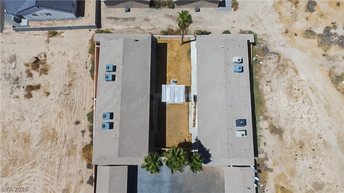1444 Star Road Pahrump, NV 89048 - Photo 30 of 37 Aerial perspective reveals the structural layout and shingle roofs of this multi-unit property.