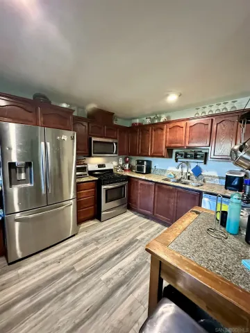 a kitchen with stainless steel appliances granite countertop a refrigerator stove and oven